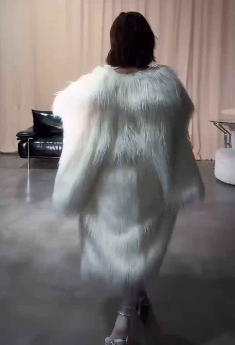 May be an image of goosedown coat, overcoat and sable coat